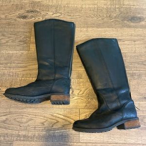 Black leather tall UGG boots with lug sole